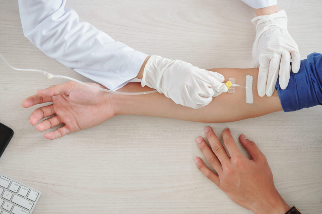 A medical provider administers specialty medications to a member through an IV