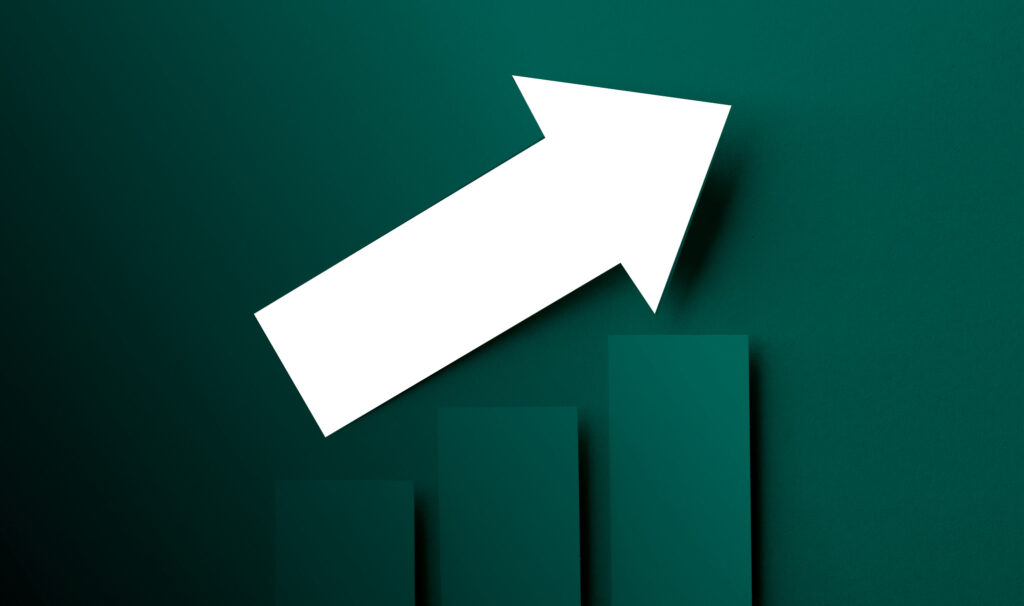 A dark green graph showing a white arrow point upward indicating a rising trend.