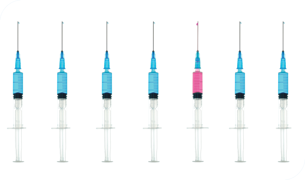 a row of syringes, all filled with blue liquid, other than a single pink one