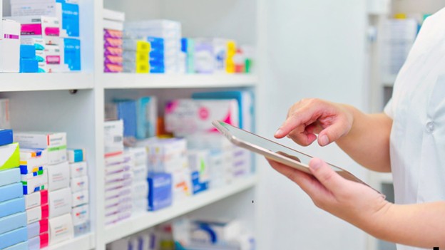 a pharmacist looking up what is a pharmacy benefits manager